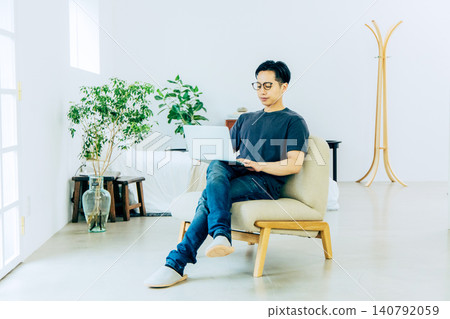 A young man working in an apartment building A young man working in an apartment building 140792059