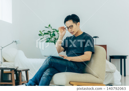 A troubled man operating a computer A troubled man operating a computer 140792063