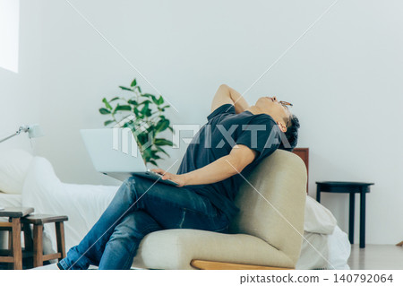 A troubled man operating a computer A troubled man operating a computer 140792064