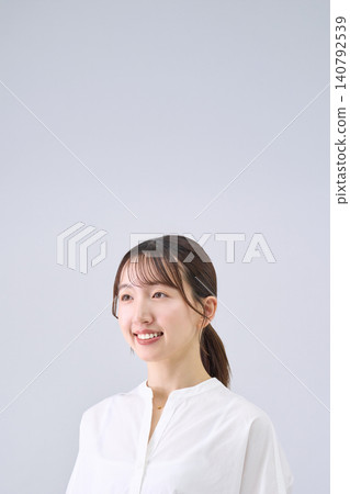 Studio portrait of a smiling Japanese woman Studio portrait of a smiling Japanese woman 140792539