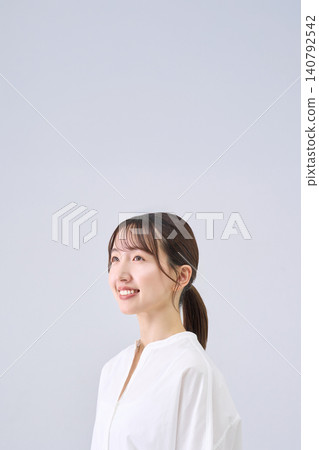 Studio portrait of a smiling Japanese woman Studio portrait of a smiling Japanese woman 140792542