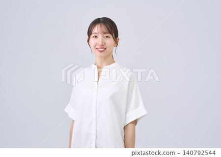 Studio portrait of a smiling Japanese woman Studio portrait of a smiling Japanese woman 140792544