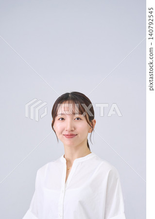 Studio portrait of a smiling Japanese woman Studio portrait of a smiling Japanese woman 140792545