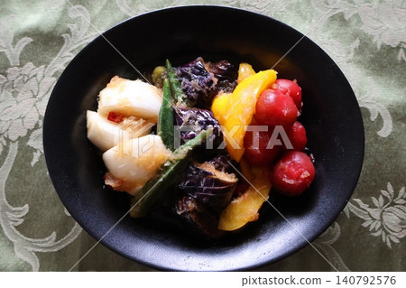 Simmered summer vegetables with grated daikon radish. Simmered summer vegetables with grated daikon radish. 140792576