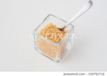 Coarse sugar in a glass container Coarse sugar in a glass container 140792716