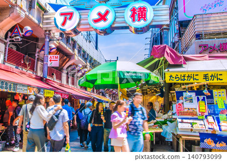 Tokyo cityscape, June 13th. Inbound tourism continues...views of bustling Ameyoko and other areas. Couples enjoying street food. Tokyo cityscape, June 13th. Inbound tourism continues...views of bustling Ameyoko and other areas. Couples enjoying street food. 140793099