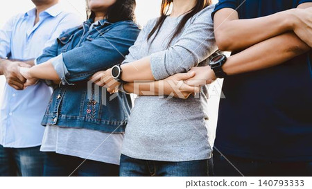 Group of people standing in line with arms crossed in a queue 140793333