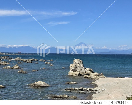 A magnificent view of Mount Fuji across Sagami Bay from Morito Shrine, and the coastal scenery with the torii gate of Najima Island. A magnificent view of Mount Fuji across Sagami Bay from Morito Shrine, and the coastal scenery with the torii gate of Najima Island. 140793464