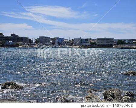The sparkling sea and the Manase fishing port and townscape of Hayama on the opposite shore, as seen from the beach behind Morito Shrine. The sparkling sea and the Manase fishing port and townscape of Hayama on the opposite shore, as seen from the beach behind Morito Shrine. 140793468