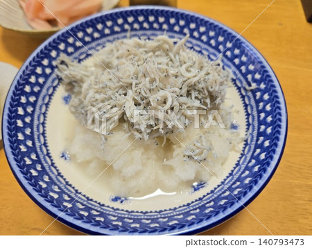 A close-up of grated daikon radish topped with fresh boiled whitebait, a souvenir from Hayama (shirasu oroshi). A close-up of grated daikon radish topped with fresh boiled whitebait, a souvenir from Hayama (shirasu oroshi). 140793473