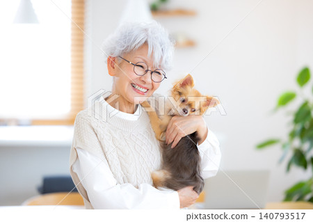 與她的寵物狗一起放鬆的老婦人 與她的寵物狗一起放鬆的老婦人 140793517