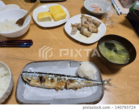A typical Japanese home-style dinner menu with a variety of dishes including grilled fish, omelet, and meat rolls. A typical Japanese home-style dinner menu with a variety of dishes including grilled fish, omelet, and meat rolls. 140793724