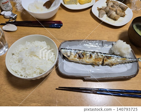 A typical Japanese home-style dinner menu: a variety of dishes including grilled fish, omelets, and meat rolls. A typical Japanese home-style dinner menu: a variety of dishes including grilled fish, omelets, and meat rolls. 140793725