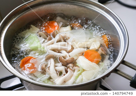 Vegetables and mushrooms being cooked in a pot Vegetables and mushrooms being cooked in a pot 140794749