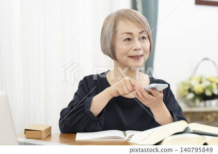 Senior women learning English conversation on their smartphones Senior women learning English conversation on their smartphones 140795849