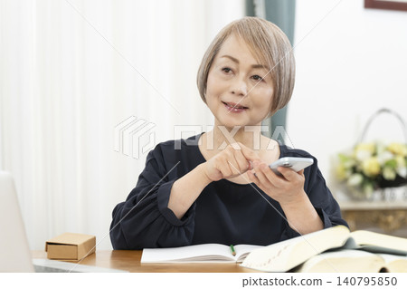 Senior women learning English conversation on their smartphones Senior women learning English conversation on their smartphones 140795850