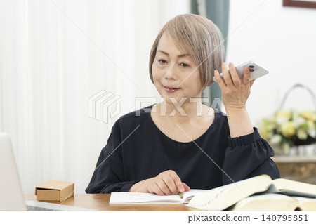 老年婦女透過智慧型手機學習英語會話 老年婦女透過智慧型手機學習英語會話 140795851