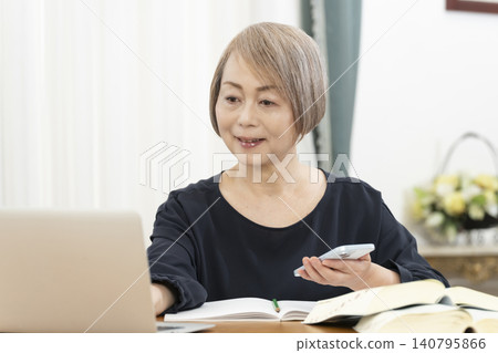 老年婦女透過智慧型手機學習英語會話 老年婦女透過智慧型手機學習英語會話 140795866