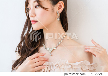 A woman's profile wearing accessories, jewelry, earrings, or piercings. A woman's profile wearing accessories, jewelry, earrings, or piercings. 140795919