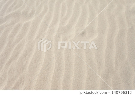 Sandy patterns created by the wind from the sand on the beach Sandy patterns created by the wind from the sand on the beach 140796313