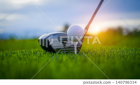 Golf clubs and balls on a green lawn in a beautiful golf course with morning sunshine. Golf clubs and balls on a green lawn in a beautiful golf course with morning sunshine. 140796334