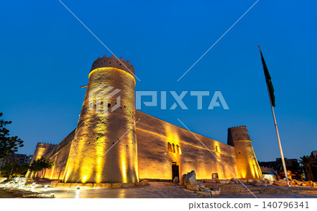 The historic Al Masmak Fortress stands illuminated against the blue hour sky in the old city center of Riyadh, Saudi Arabia. The historic Al Masmak Fortress stands illuminated against the blue hour sky in the old city center of Riyadh, Saudi Arabia. 140796341