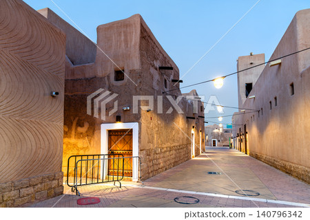 A beautifully lit traditional clay and mud brick alleyway in the historic Al Doho district of Riyadh, Saudi Arabia at dusk 140796342