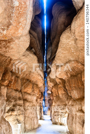 Dramatic view of the interior sandstone caves at Al Qarah Mountain, a natural geological landmark in the Al Ahsa oasis, Saudi Arabia Dramatic view of the interior sandstone caves at Al Qarah Mountain, a natural geological landmark in the Al Ahsa oasis, Saudi Arabia 140796344