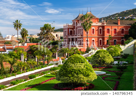 A beautiful view of the historic red Taoro Lyceum and the terraced Jardines del Marquesado de la Quinta Roja in La Orotava, Tenerife, Spain A beautiful view of the historic red Taoro Lyceum and the terraced Jardines del Marquesado de la Quinta Roja in La Orotava, Tenerife, Spain 140796345
