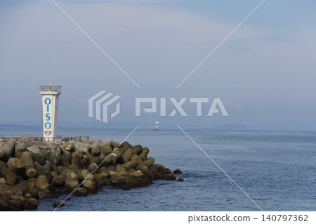 The lighthouse at the west breakwater of Oiso Port and the tranquil scenery of Sagami Bay. The lighthouse at the west breakwater of Oiso Port and the tranquil scenery of Sagami Bay. 140797362