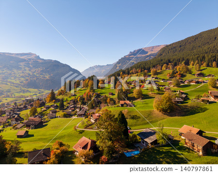 Autumn scenery of green hills and traditional chalets in the Swiss Alps. Grindelwald, Bern Canton, Switzerland Autumn scenery of green hills and traditional chalets in the Swiss Alps. Grindelwald, Bern Canton, Switzerland 140797861