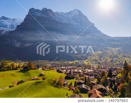 Autumn scenery of Grindelwald town with the Eiger North Face in the background, Grindelwald, Bern Canton, Switzerland Autumn scenery of Grindelwald town with the Eiger North Face in the background, Grindelwald, Bern Canton, Switzerland 140797863