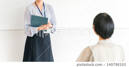 Female lecturer lecturing in front of a whiteboard at a cram school, seminar, or workshop, teacher, cram school instructor Female lecturer lecturing in front of a whiteboard at a cram school, seminar, or workshop, teacher, cram school instructor 140798103