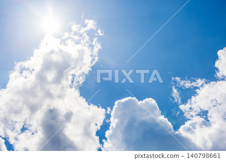 Dynamic white clouds rising up, framing the blue sky. 140798661