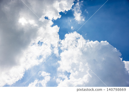 Dynamic white clouds rising up, framing the blue sky. Dynamic white clouds rising up, framing the blue sky. 140798669