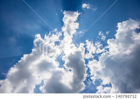 Dynamic white clouds rising up, framing the blue sky. Dynamic white clouds rising up, framing the blue sky. 140798712