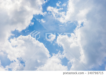 Dynamic white clouds rising up, framing the blue sky. Dynamic white clouds rising up, framing the blue sky. 140798715