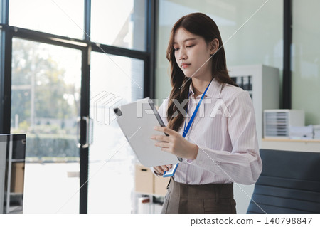 Young businesswoman professional employee using pc doing online banking analysing at workplace. Asian middle-aged business woman working on laptop computer in office, taking notes. Banner, copy space 140798847