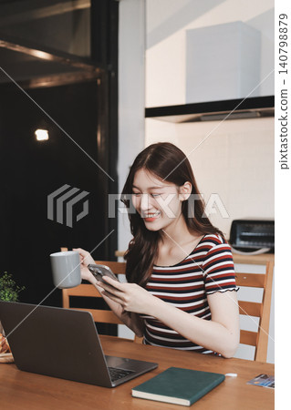 Asian woman using computer remote for business studying, watching online virtual webinar training meeting, video call. asian business woman talking on laptop in home office. Banner, copy space Asian woman using computer remote for business studying, watching online virtual webinar training meeting, video call. asian business woman talking on laptop in home office. Banner, copy space 140798879