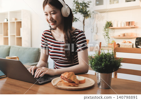 Asian woman using computer remote for business studying, watching online virtual webinar training meeting, video call. asian business woman talking on laptop in home office. Banner, copy space 140798891