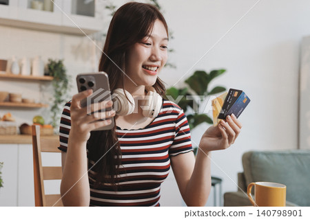 Happiness Entrepreneur beautiful business asian young woman wear casual use mobile phone for shopping online enjoy with social media and laptop at home.Small Business Startup.online banking Happiness Entrepreneur beautiful business asian young woman wear casual use mobile phone for shopping online enjoy with social media and laptop at home.Small Business Startup.online banking 140798901