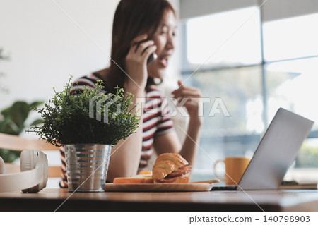 Happiness Entrepreneur beautiful business asian young woman wear casual use mobile phone for shopping online enjoy with social media and laptop at home.Small Business Startup.online banking 140798903