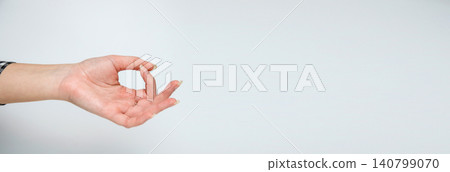 Woman hand showing meditation mudra gesture on light background. Minimalist zen, yoga and mindfulness banner with copy space Woman hand showing meditation mudra gesture on light background. Minimalist zen, yoga and mindfulness banner with copy space 140799070