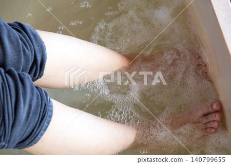A man and a woman paddle on the surface of the sea. A man and a woman paddle on the surface of the sea. 140799655