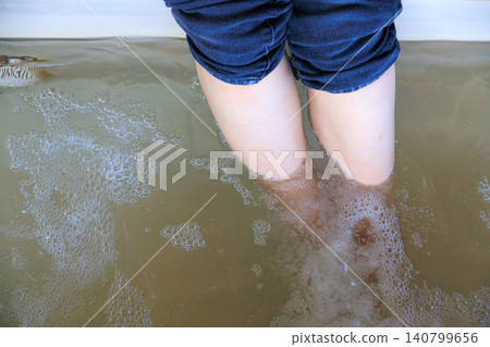 A man and a woman paddle on the surface of the sea. A man and a woman paddle on the surface of the sea. 140799656