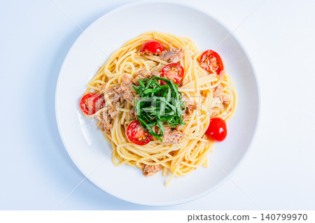 Cold pasta with tuna and cherry tomatoes, garnished with shiso leaves - a perfect summer dish. Cold pasta with tuna and cherry tomatoes, garnished with shiso leaves - a perfect summer dish. 140799970