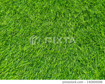 Vibrant Green Artificial Grass Texture Lush Synthetic Turf Background outdoor landscaping, sports field backgrounds, and modern floor coverings. Vibrant Green Artificial Grass Texture Lush Synthetic Turf Background outdoor landscaping, sports field backgrounds, and modern floor coverings. 140800096