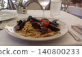 A delicious-looking authentic pasta dish I ate on my trip to Italy (spaghetti with tomato sauce and mussels). 140800233