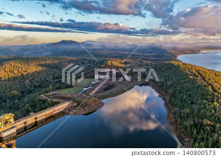 Aerial view showcasing the Lake Keepit dam wall and surrounding rural landscape, highlighting the scale of the reservoir, engineering infrastructure and tranquil lakeside setting in NSW, Australia. Aerial view showcasing the Lake Keepit dam wall and surrounding rural landscape, highlighting the scale of the reservoir, engineering infrastructure and tranquil lakeside setting in NSW, Australia. 140800573