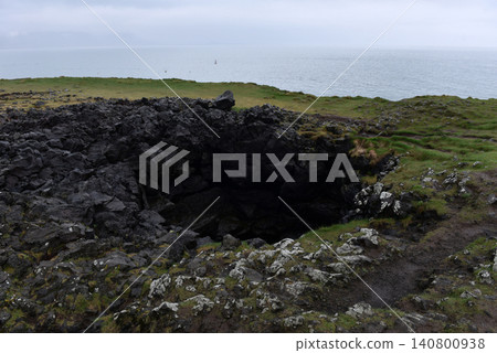 Large volcanic pit on the coastal plateau of Arnarstapi, Iceland Large volcanic pit on the coastal plateau of Arnarstapi, Iceland 140800938